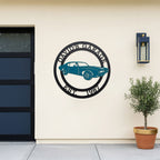 Custom garage metal wall sign featuring classic muscle car design with personalized garage name and established date mounted on modern exterior wall
