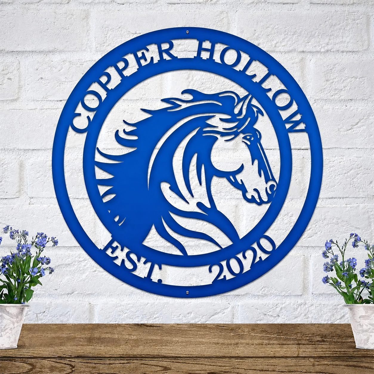 Blue personalized horse ranch metal sign with custom farm name and established year mounted on white brick wall decor for barns stables and equestrian homes