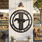Black custom horse ranch metal sign displayed on barn post with horses and ranch equipment in background