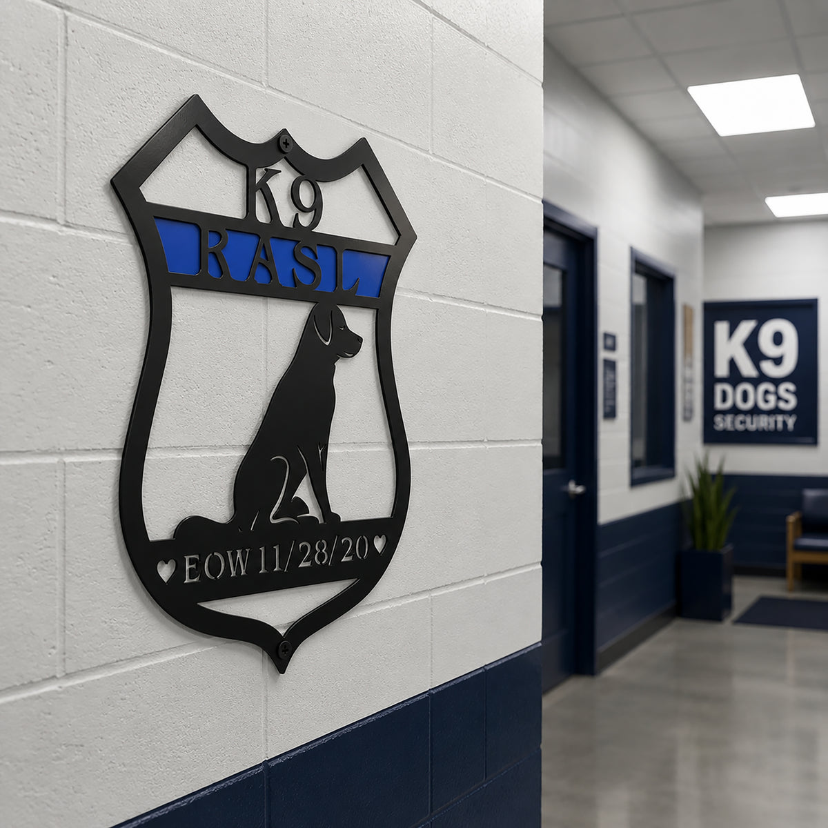 Personalized K9 memorial badge metal sign mounted on a hallway wall inside a K9 unit facility with blue and white interior
