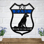 Black shield-shaped metal sign with a dog silhouette, blue line nameplate, and personalized EOW date memorial.