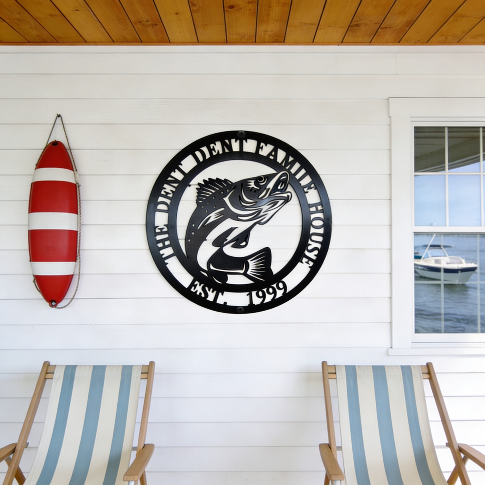 Black personalized lake house fish metal wall decor on porch with boat and lake view