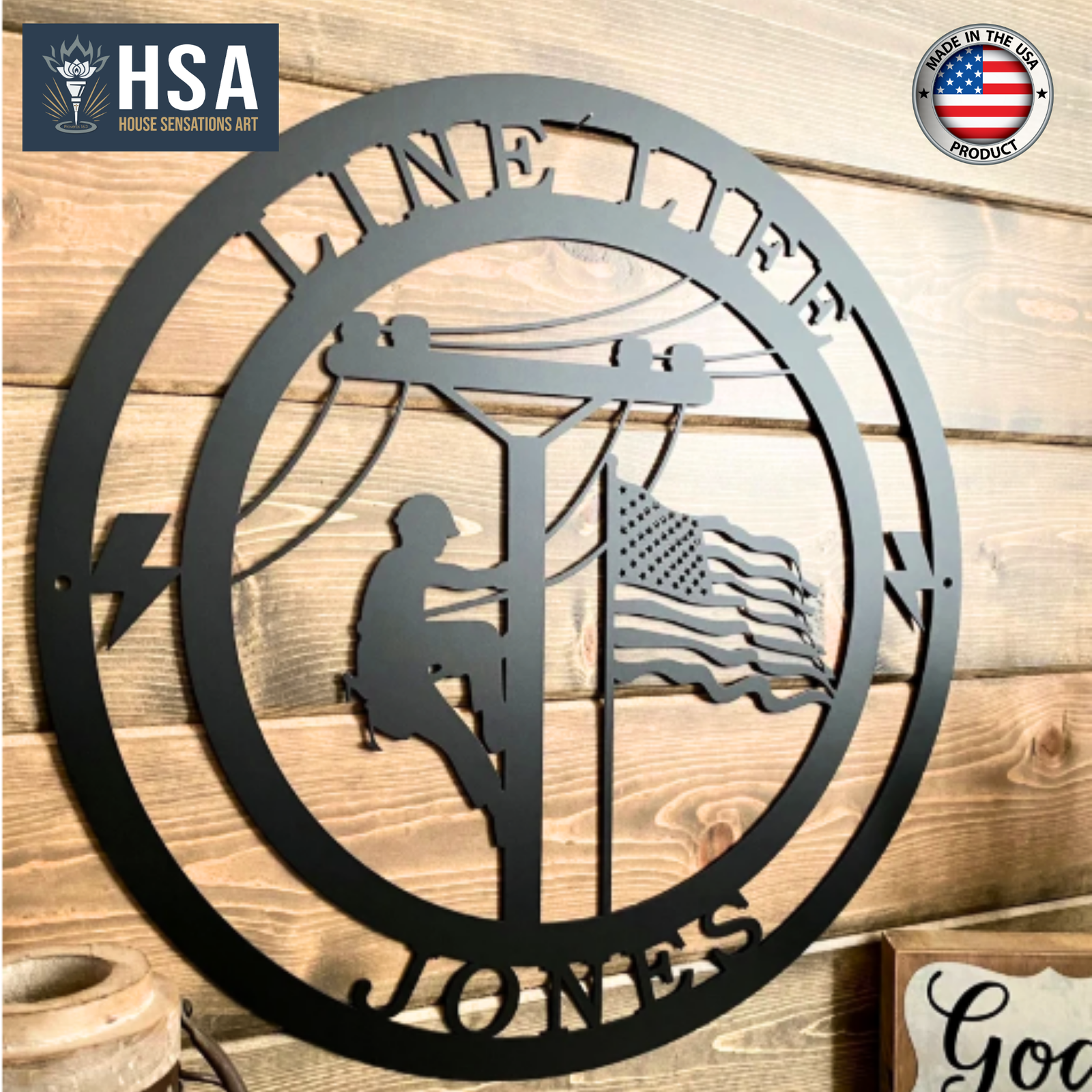 Decorative metal wall art featuring a silhouette of a person climbing a pole, an American flag, and “HSA” branding, displayed on a wooden background, creating a patriotic and industrial-style décor piece.