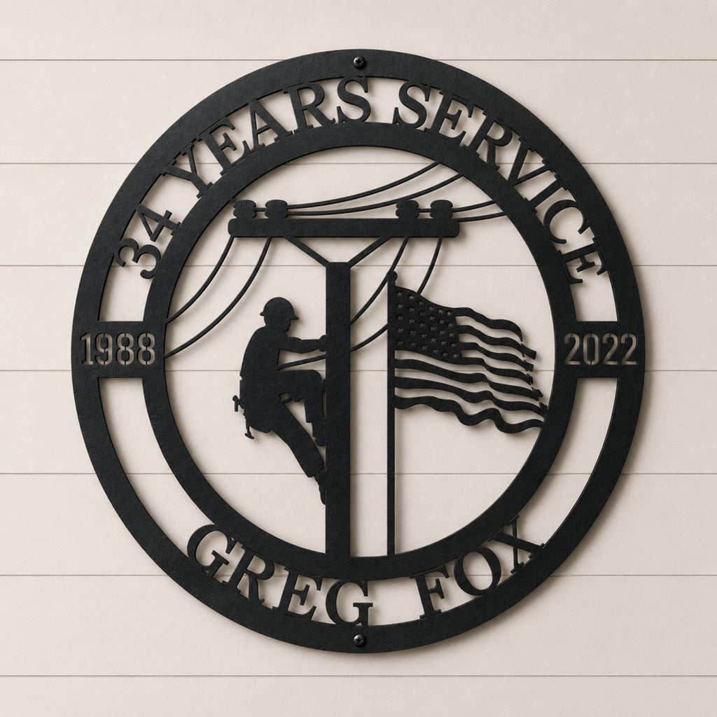 Personalized lineman metal wall sign featuring utility worker climbing power pole with American flag custom years and service company name in black steel décor