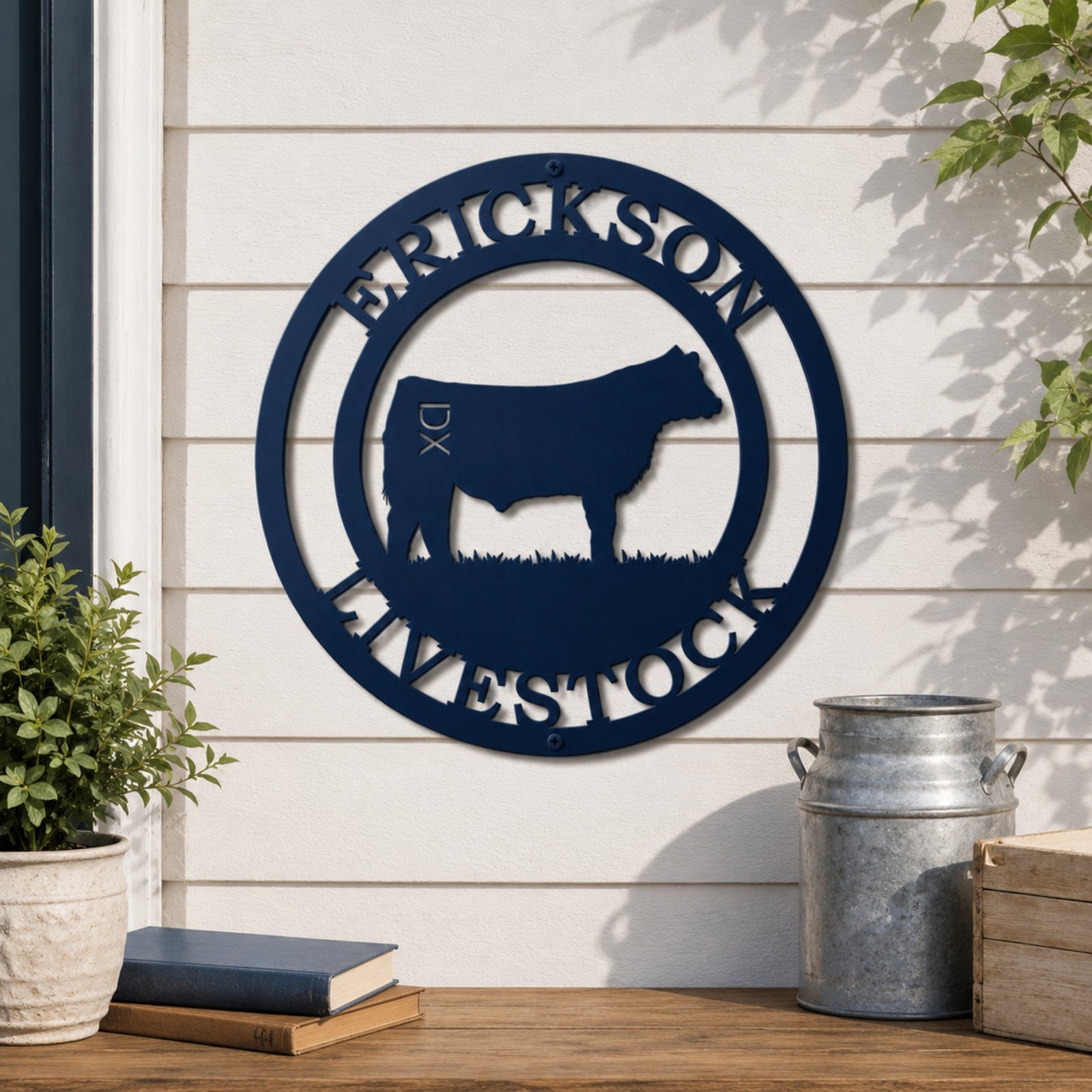 Custom blue livestock metal wall sign with cattle silhouette and family farm name displayed on farmhouse exterior wall