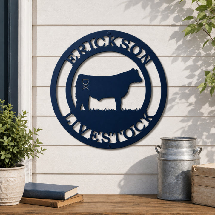 Custom blue livestock metal wall sign with cattle silhouette and family farm name displayed on farmhouse exterior wall
