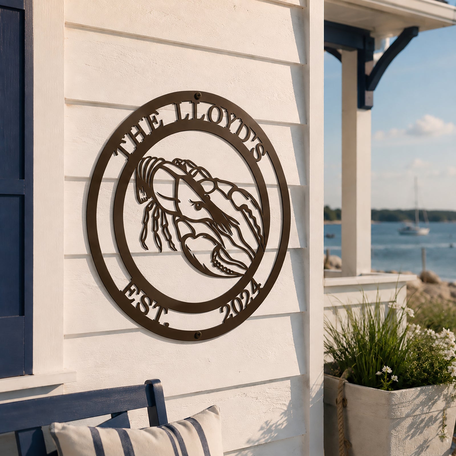 Espresso lobster metal wall sign with The Lloyds and Est 2024 mounted on white coastal siding
