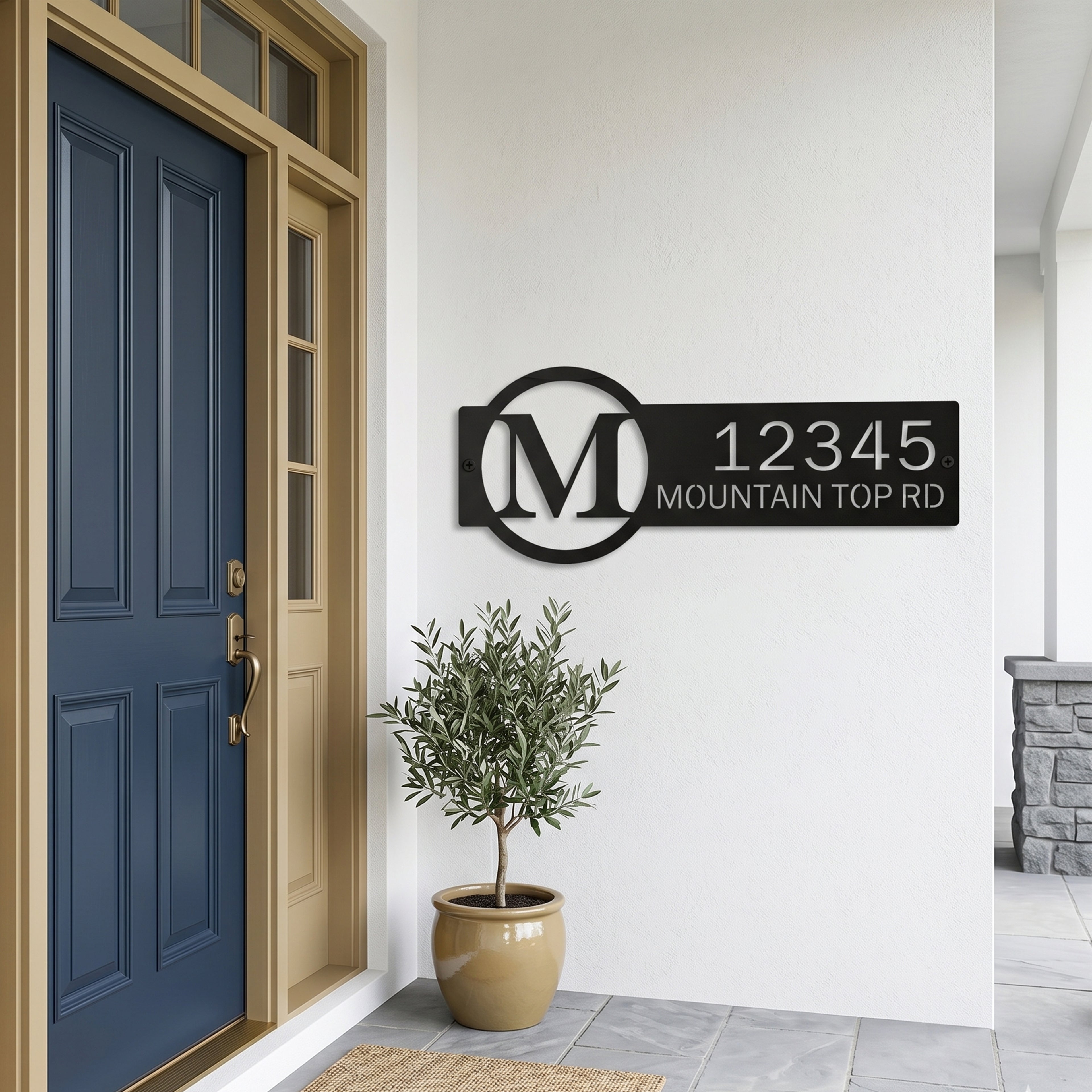 Black personalized monogram metal address sign displayed beside blue front door