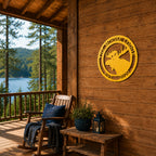 Yellow personalized moose lodge metal wall sign displayed on rustic cabin porch overlooking forest and lake scenery