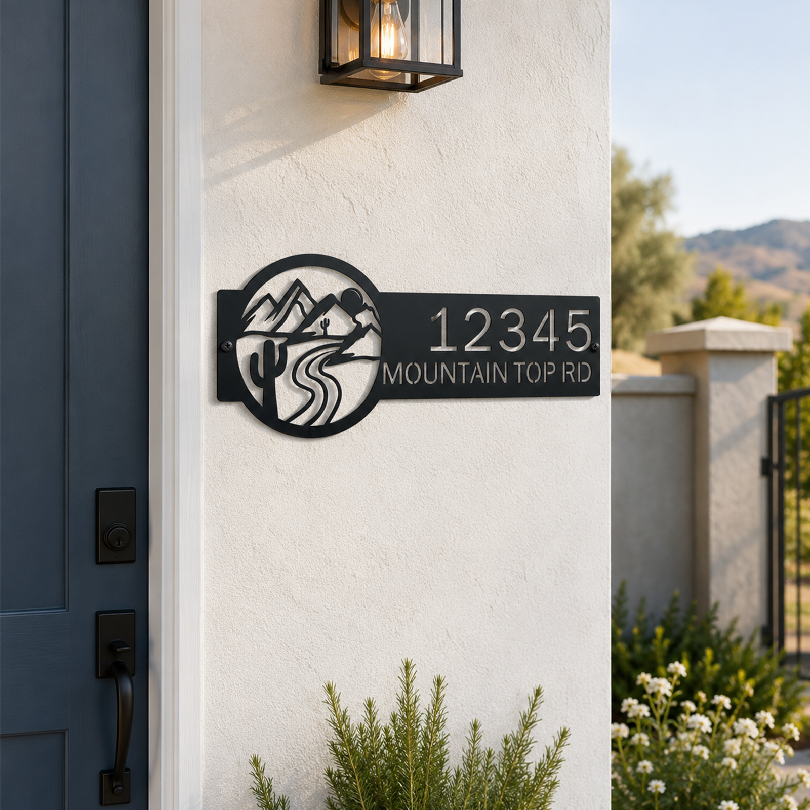 Black personalized mountain top road metal address sign mounted beside front door