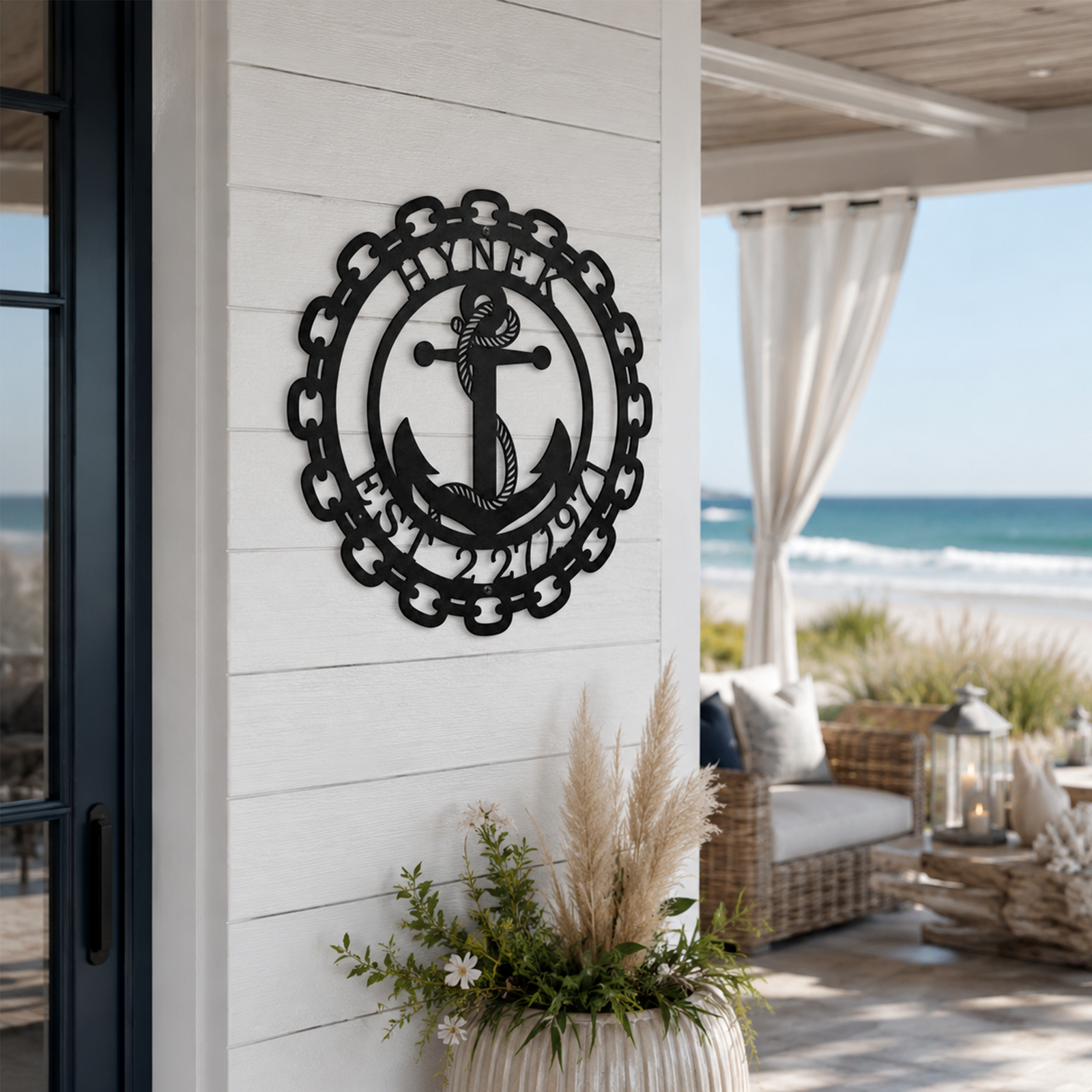 Custom laser-cut black metal anchor sign with chain link frame and established date displayed prominently in a beautifully styled beach house dining room.