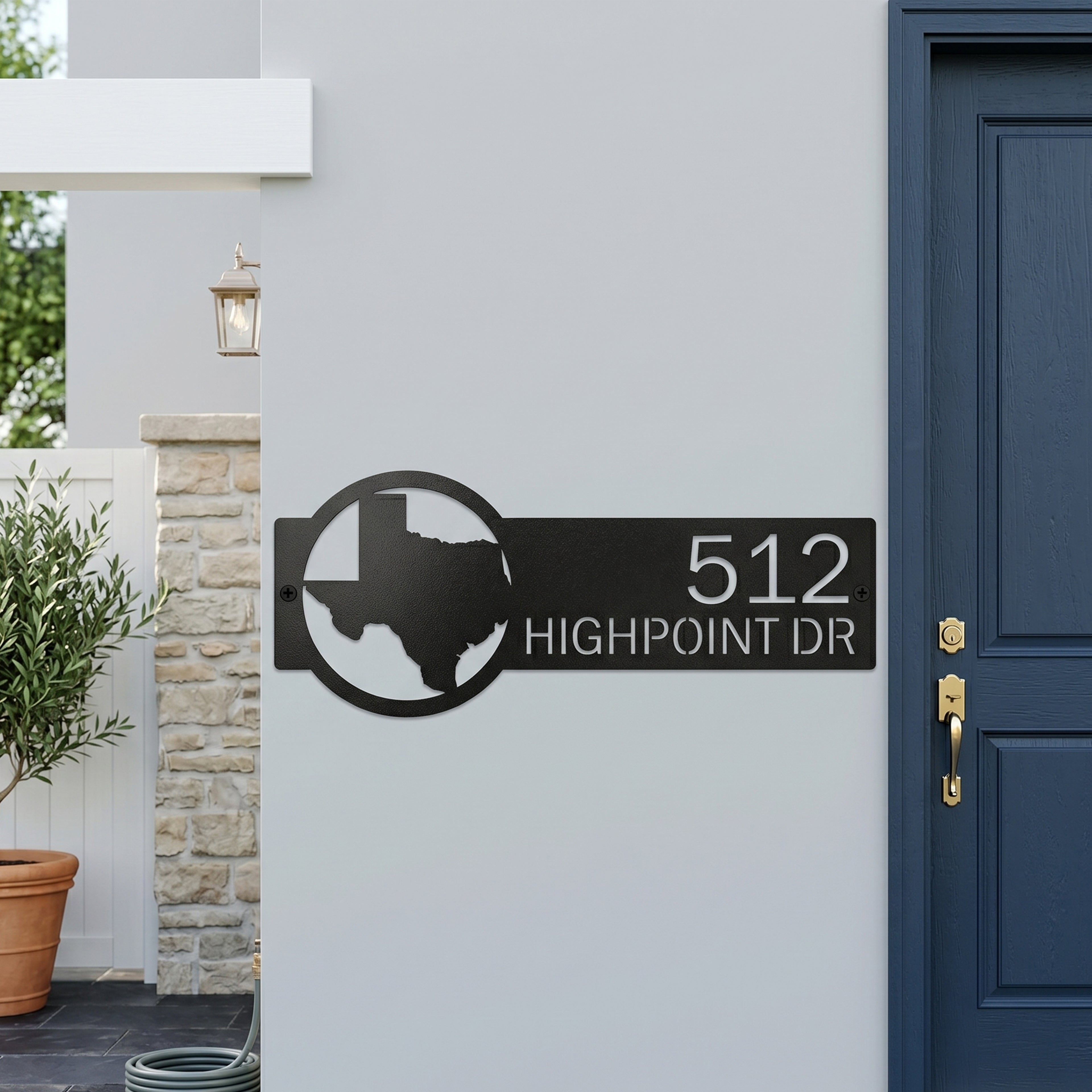 Custom Texas metal address sign with house numbers displayed on modern exterior wall near front entrance