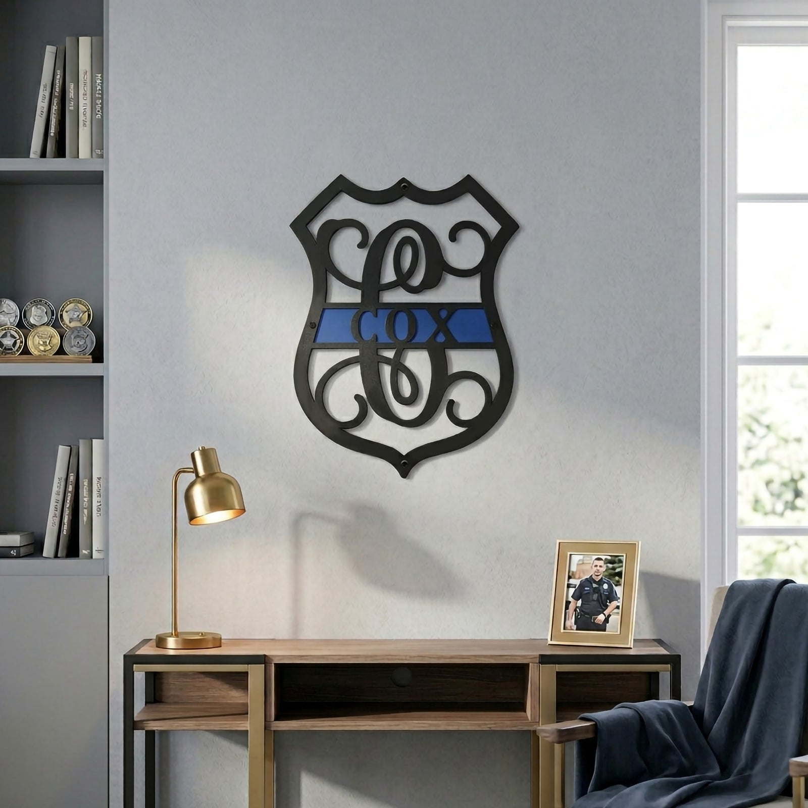 Custom police themed metal monogram wall sign with blue stripe displayed above wooden console table in office setting