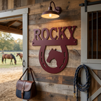 Garnet Rocky horse horseshoe metal sign with horse head design mounted on barn wood wall near saddle bag and rope décor