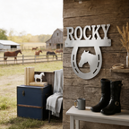 Raw metal Rocky horse horseshoe sign with horse head silhouette mounted on rustic wood wall near a farm pasture