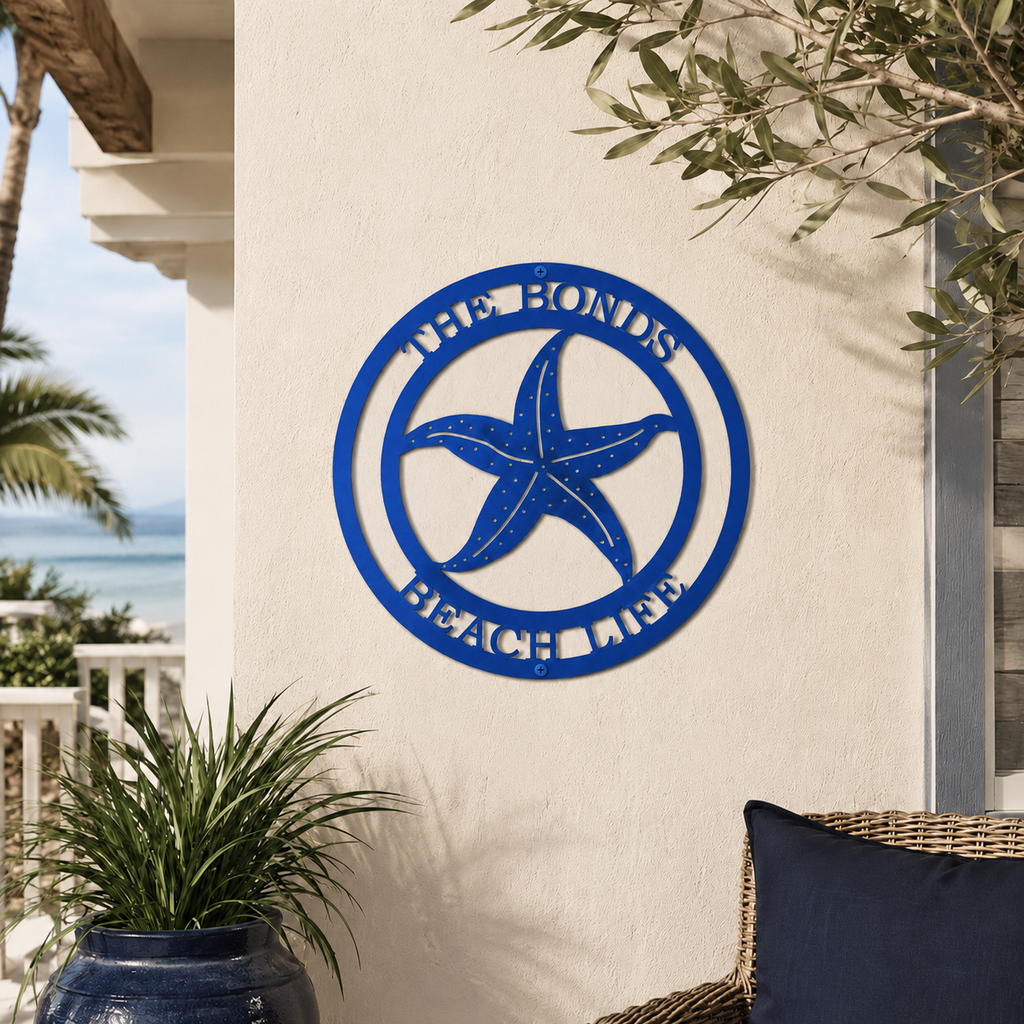 Vibrant blue custom metal starfish family sign mounted on an outdoor stucco wall above a large glossy blue planter on a sunny patio.