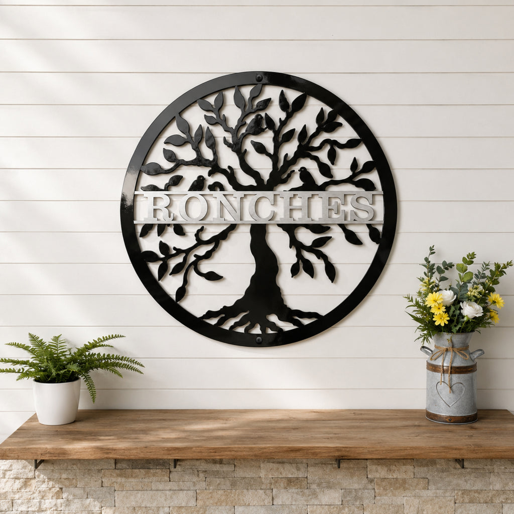 Large black tree of life metal wall sign with personalized family name displayed on white shiplap wall with rustic decor