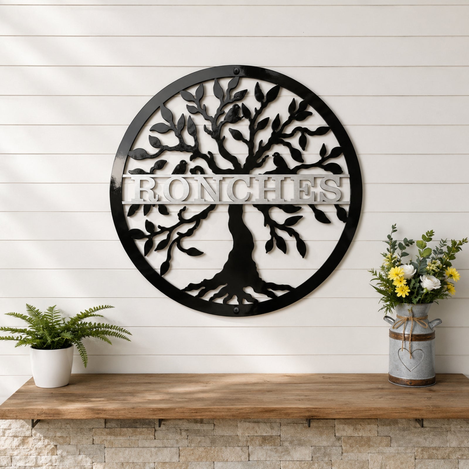 Large black tree of life metal wall sign with personalized family name displayed on white shiplap wall with rustic decor