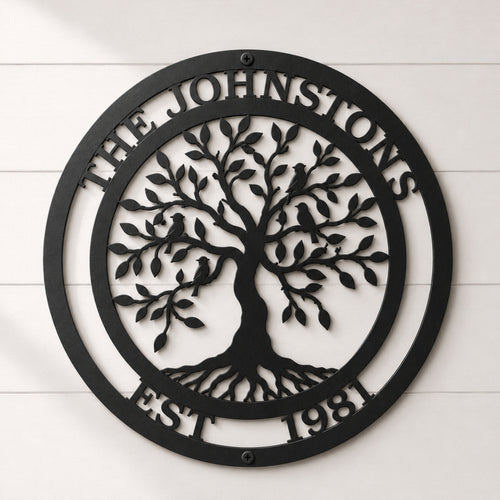 Black circular personalized family tree metal sign featuring The Johnstons name, established date and birds on a white shiplap wall