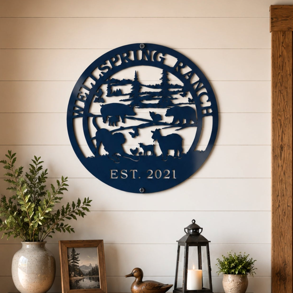 Navy blue custom ranch metal sign with farm animal silhouette mounted above rustic farmhouse console table