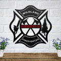 Black metal Maltese cross sign with axes, chainsaw, and tree, featuring a personalized red Woodward nameplate.
