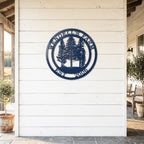 Custom navy blue ranch metal sign with farm animals and EST 2021 displayed on rustic farmhouse porch wall