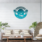 Rebecca Belle Vue turquoise welcome metal sign displayed on coastal patio wall