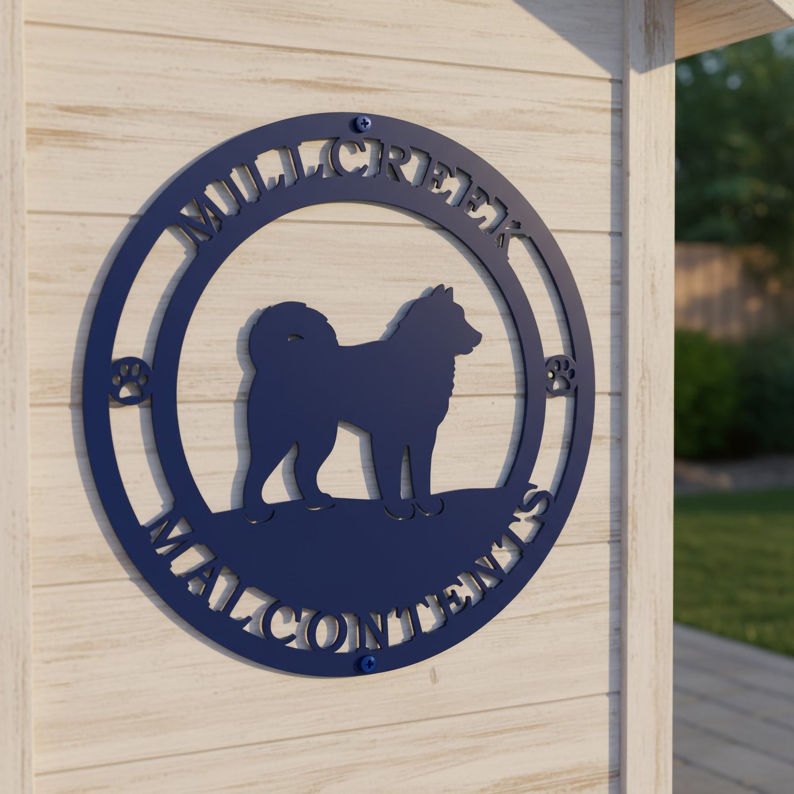 Close up of royal blue Mill Creek Malcontents dog sign mounted on a light wood dog house wall