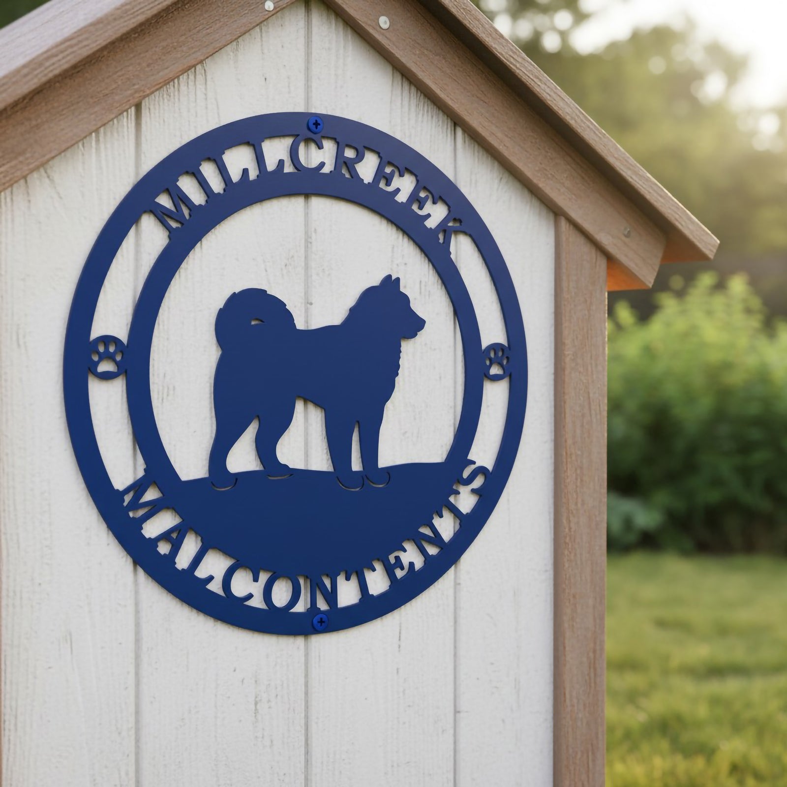 Blue personalized dog metal sign with paw accents displayed on a rustic white wooden dog house