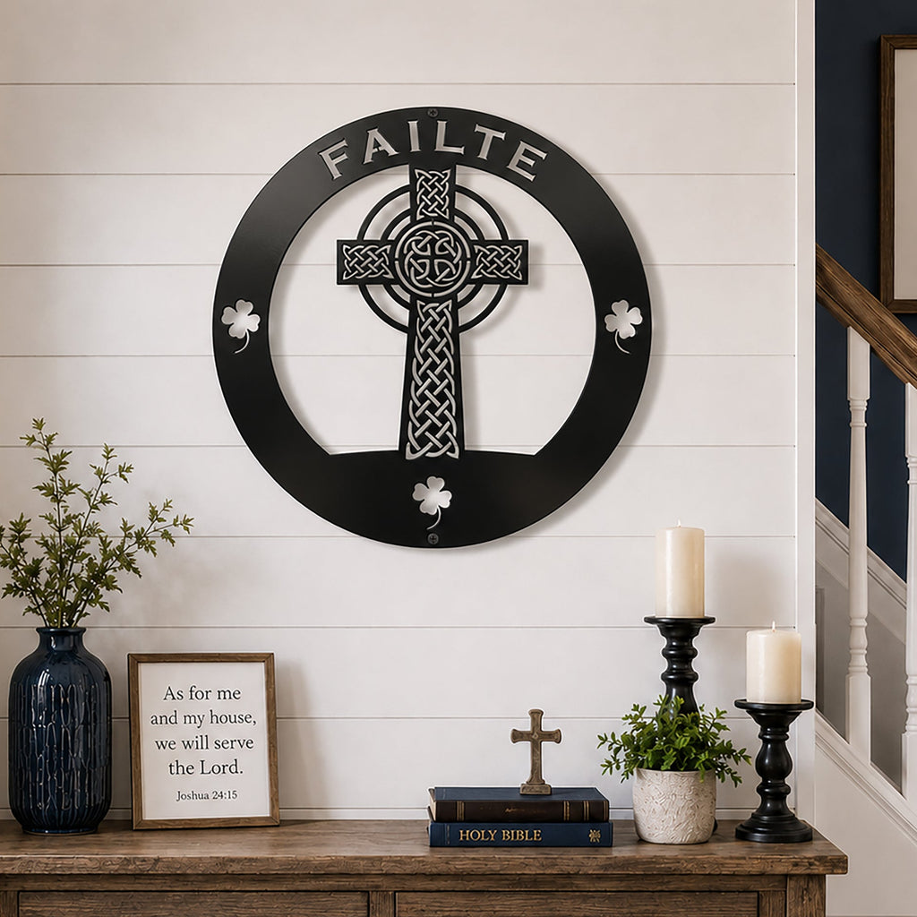 Black Celtic cross metal wall art with Failte welcome text displayed above a rustic wooden console table with Christian decor