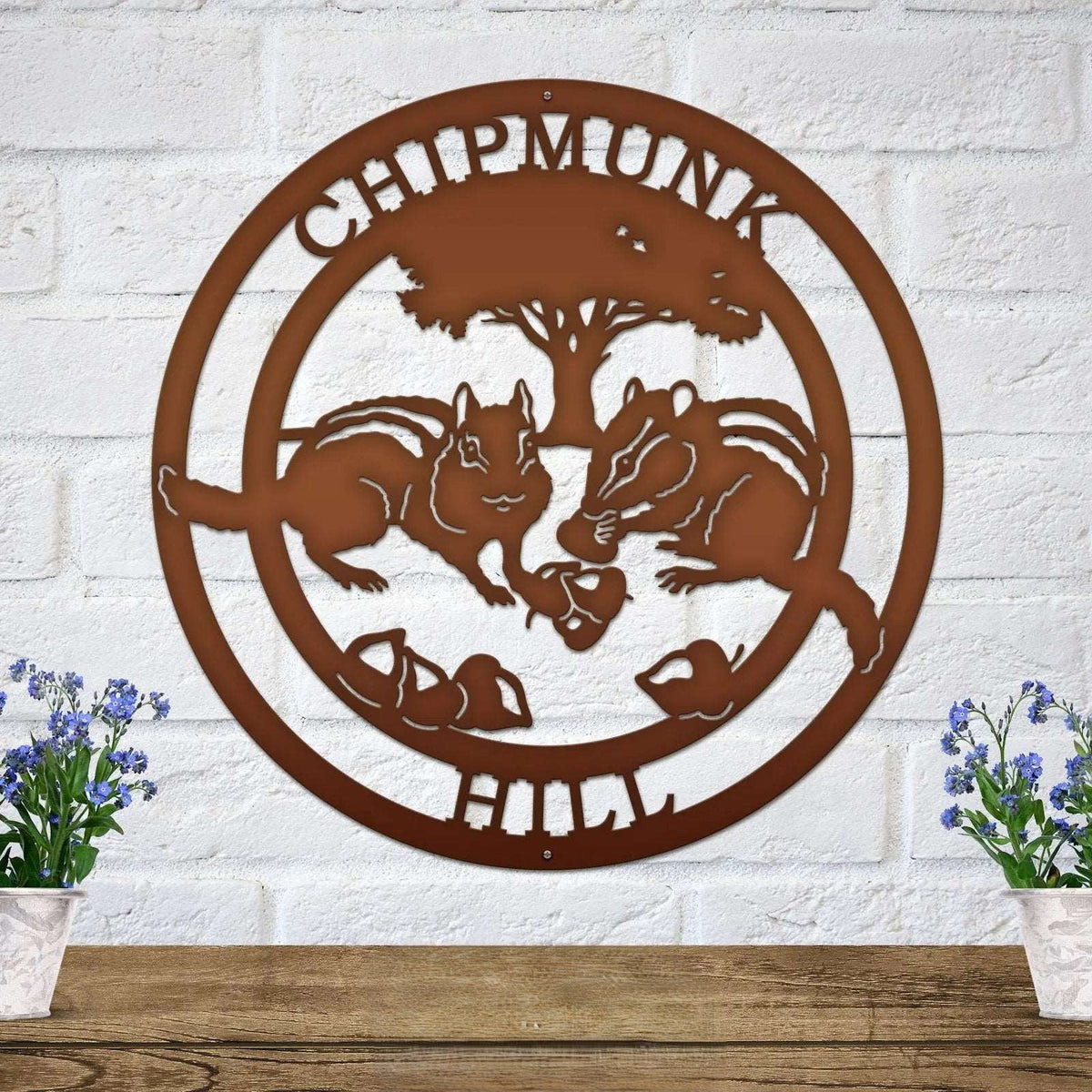 Rustic brown chipmunk hollow metal wall decor with woodland animal scene and tree silhouette mounted on white brick wall