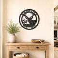 Personalized deer metal wall decor with farm name and established year displayed above wooden entryway table in farmhouse home