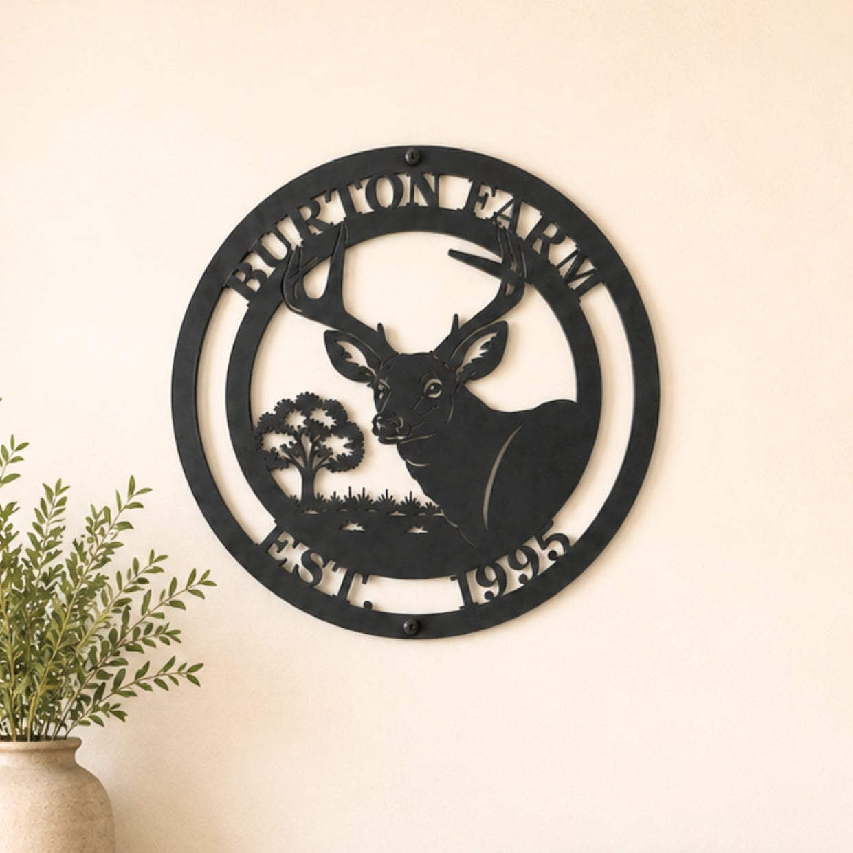 Personalized deer metal wall decor with farm name and established year displayed above wooden entryway table in farmhouse home