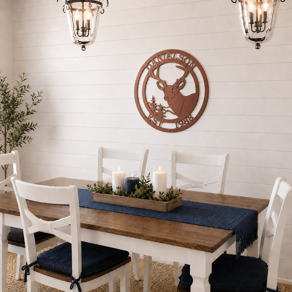 Rose gold deer metal wall art with custom family name hanging above farmhouse dining table
