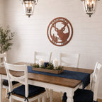 Rose gold deer metal wall art with custom family name hanging above farmhouse dining table