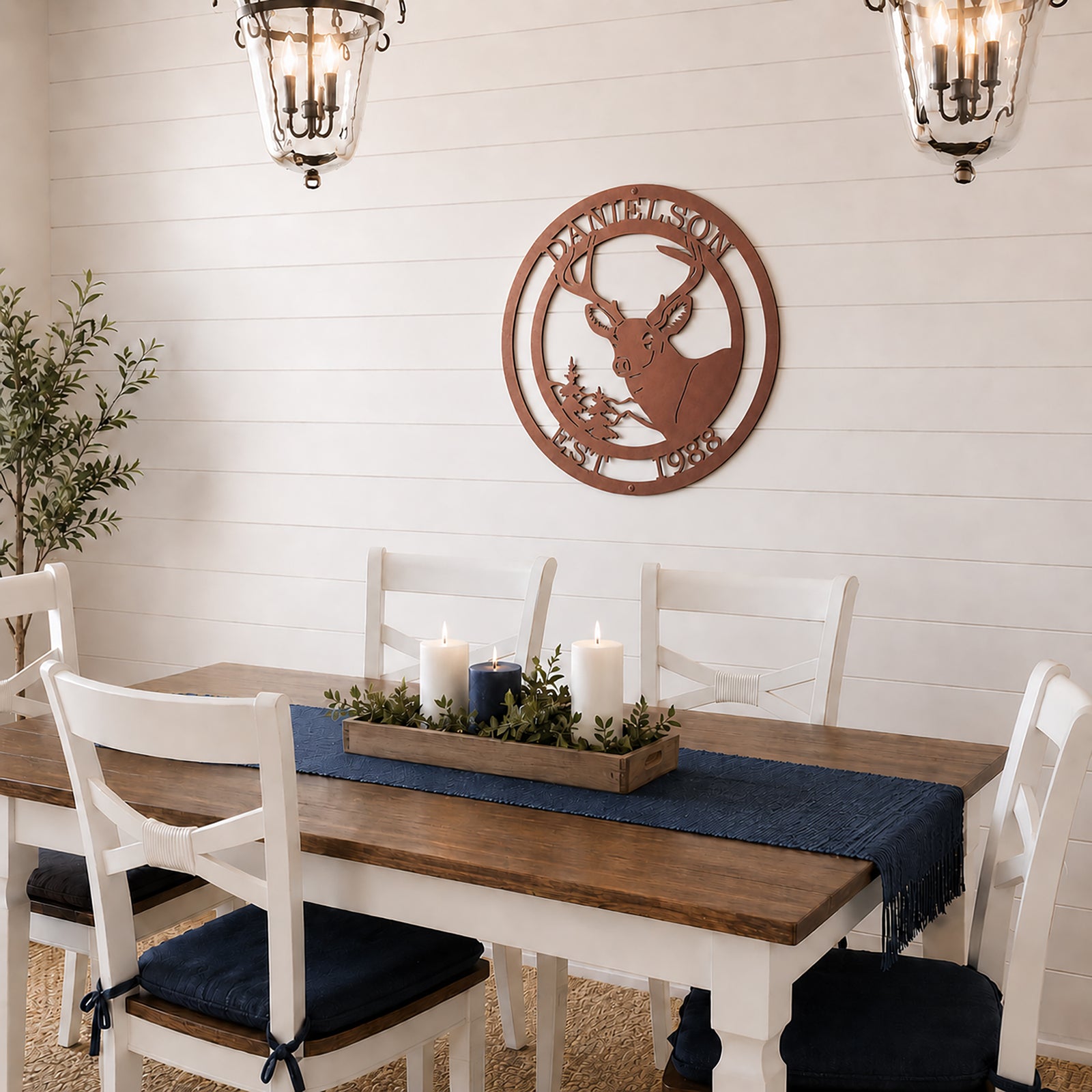 Rose gold deer metal wall art with custom family name hanging above farmhouse dining table