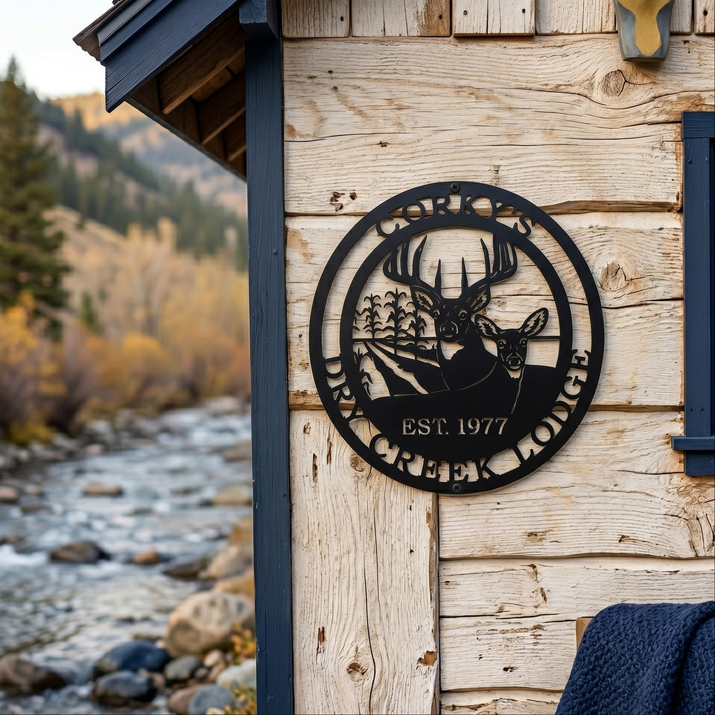 Black Corky’s Dry Creek Lodge metal wall plaque with buck doe and corn field design displayed on rustic cabin siding