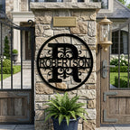 Personalized Robertson metal monogram sign attached to a stone gate pillar with outdoor lantern decor