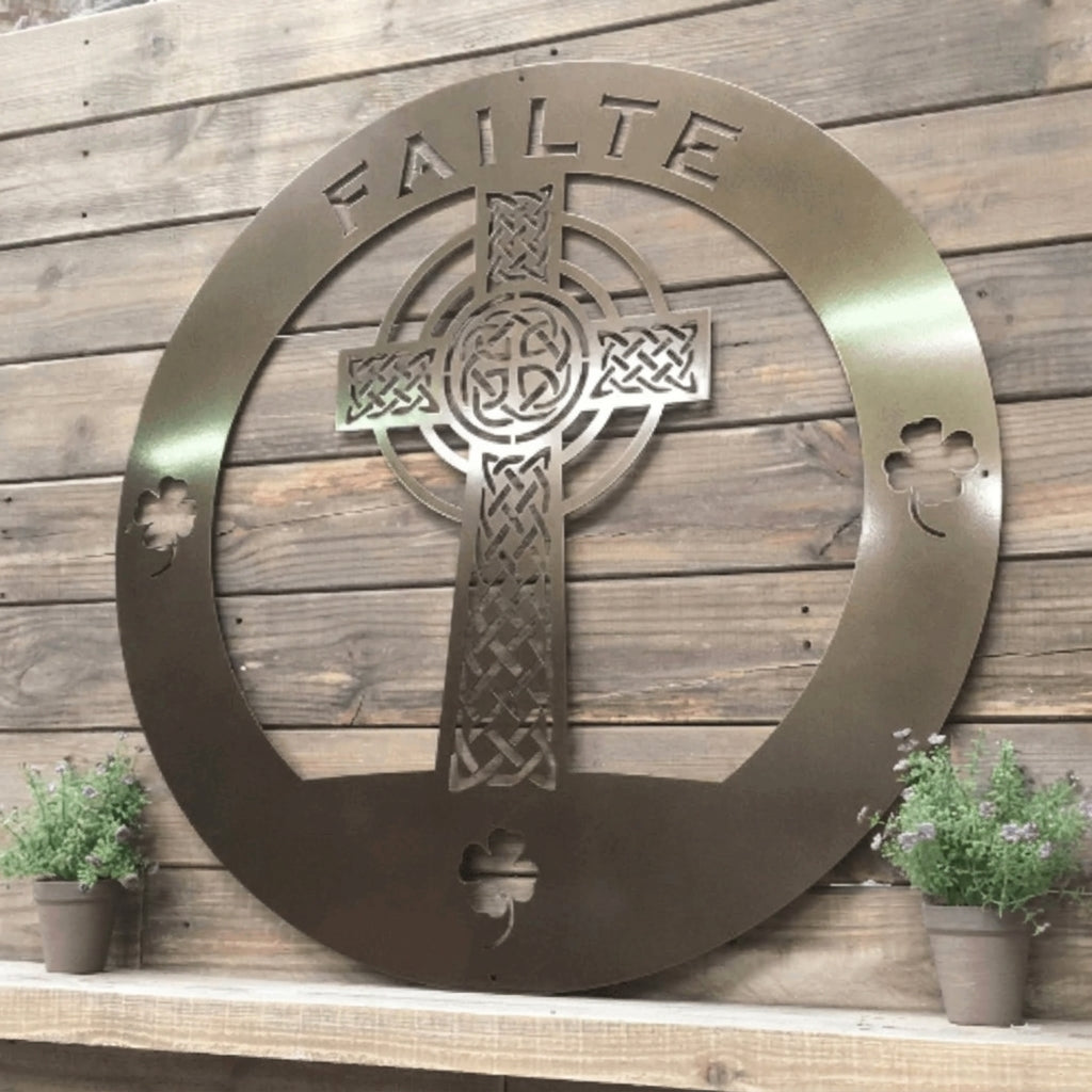 Rustic metal Celtic cross wall décor with shamrock details displayed against reclaimed wood background