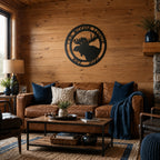 Black moose lodge personalized metal wall art hanging above leather sofa in cozy rustic cabin living room