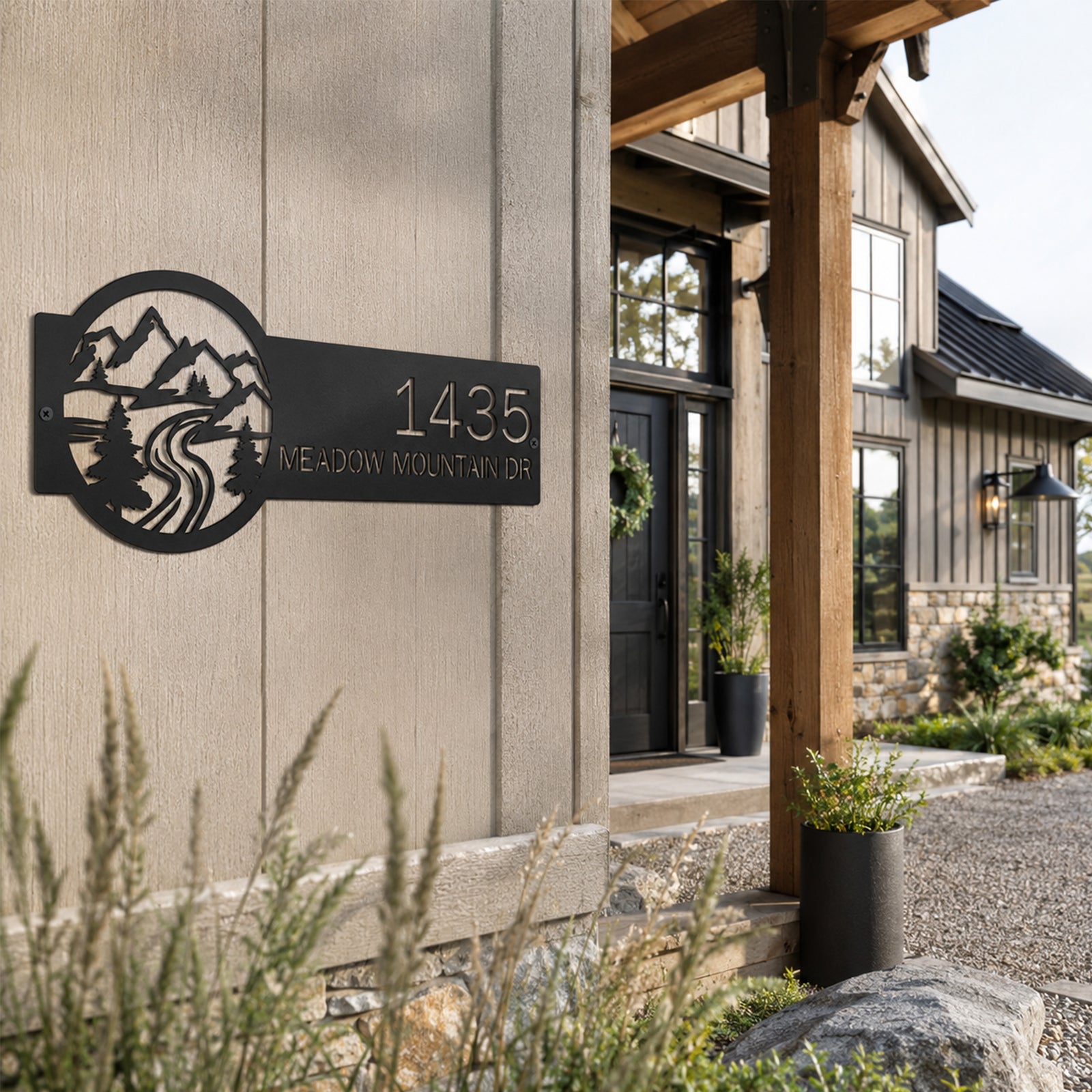 Black personalized mountain address sign with custom house number and scenic mountain artwork mounted on modern farmhouse exterior wall