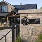 Black rooster farmhouse address plaque attached to stone gate column featuring custom house number and rural barn scene outdoor metal wall decor