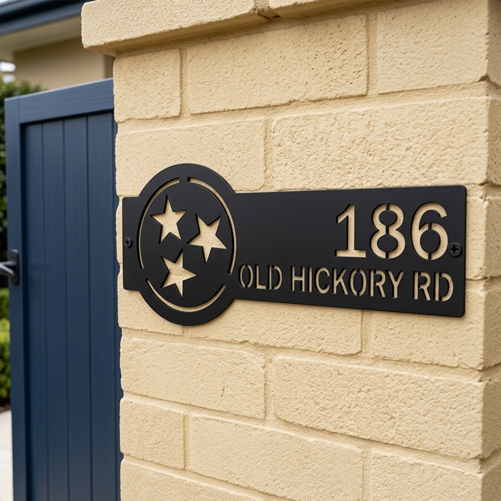 Black Tennessee tri star custom address plaque mounted on brick pillar with modern outdoor house styling