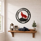 Custom wolf lodge metal wall décor displayed above wooden shelf with lantern books and cabin accessories