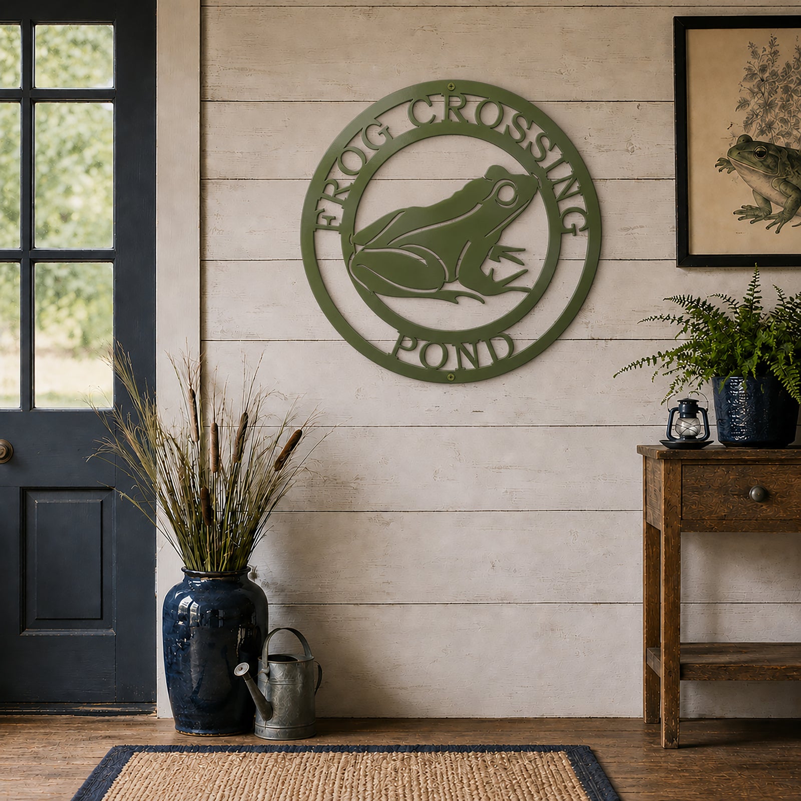 Sage green frog pond metal wall art mounted on farmhouse style white wood wall with botanical decor