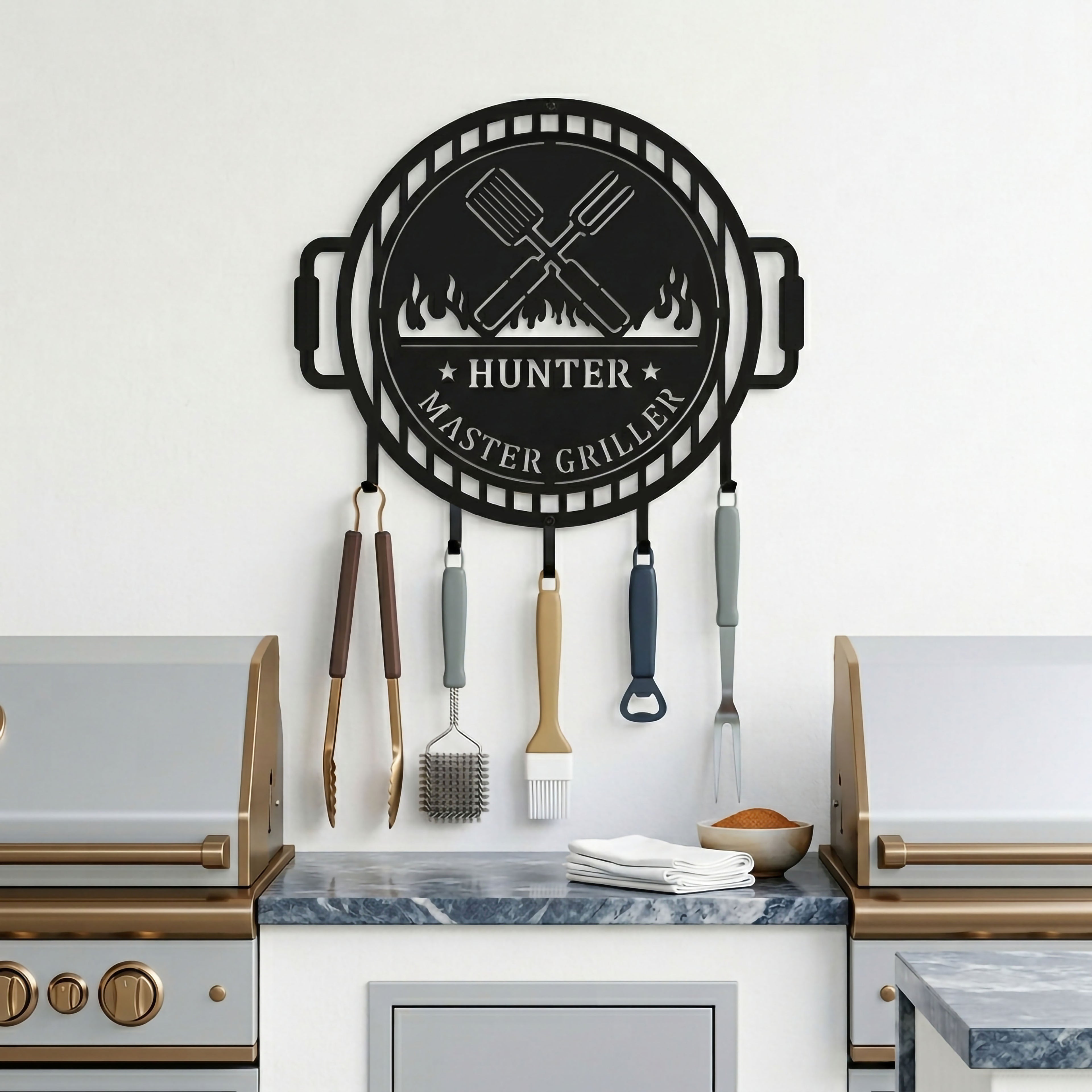 Satin black BBQ grill tool holder metal sign mounted above outdoor counter with grilling tools and barbecue accessories