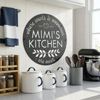 Satin black mimis kitchen metal wall sign displayed above kitchen counter with ceramic canisters and farmhouse decor accents