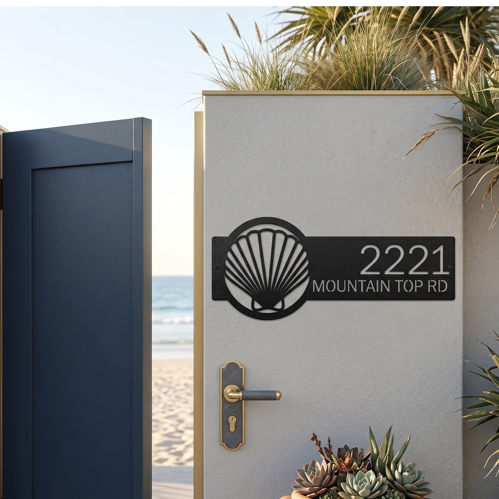 Black seashell address plaque with house number mounted on beach gate wall