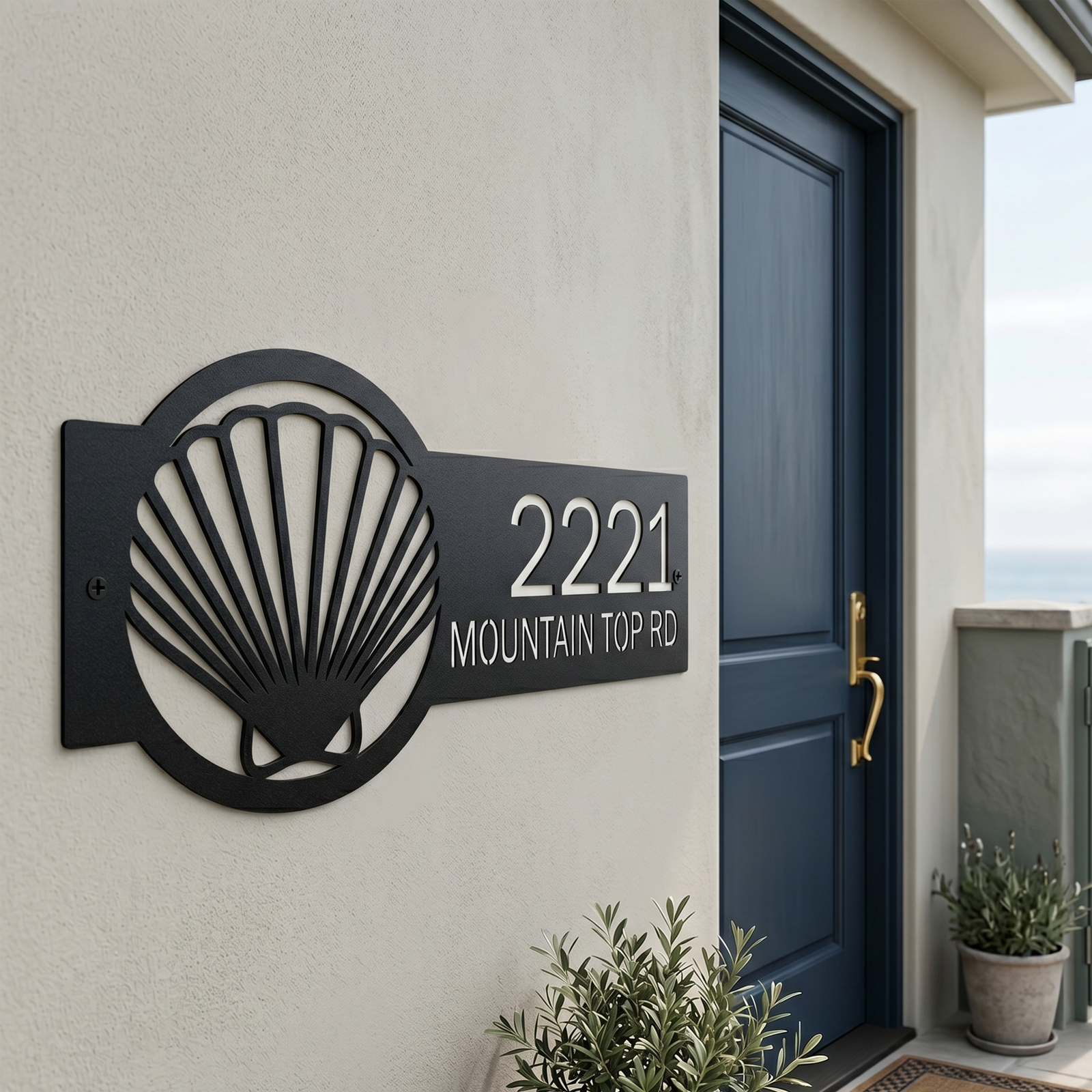 Black seashell address plaque with house number mounted beside blue front door