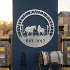 Silver Mystic Raven Farm metal sign with two horses and raven design mounted on a dark blue wall near saddle and tack decor